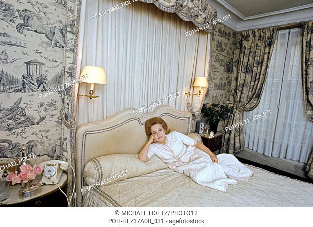 American actress Olivia de Havilland posing in the bedroom of her Paris apartment located 3 rue Bénouville in the 16th arrondissement. c