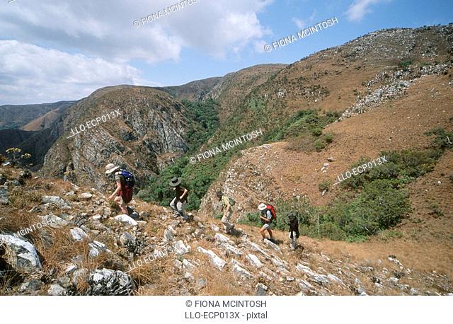 Hikers Ascending the Rocky Mountain Side  Mafinga Mountains, Malawi, Africa