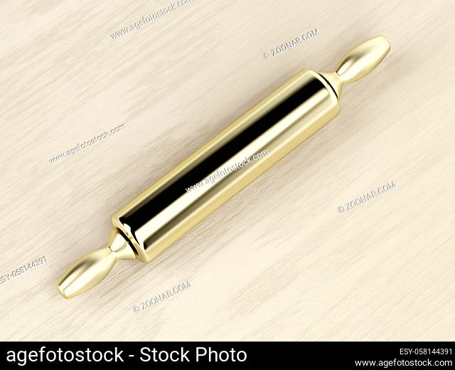 Golden rolling pin on the wooden table, top view