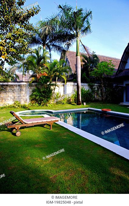 Swimming pool in front of outdoor chair