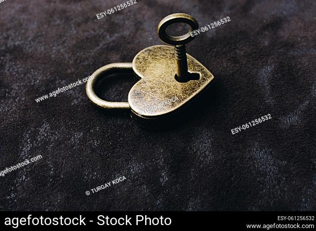 Metal padlock in heart shape as symbol of love
