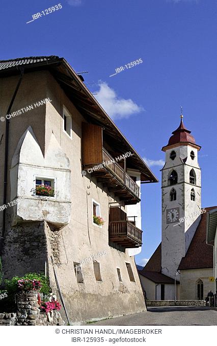 Old house and the church inaugurated to the saints of Ulrich and Wolfgang, Deutschnofen, Eggen valley, South Tyrol, Italy