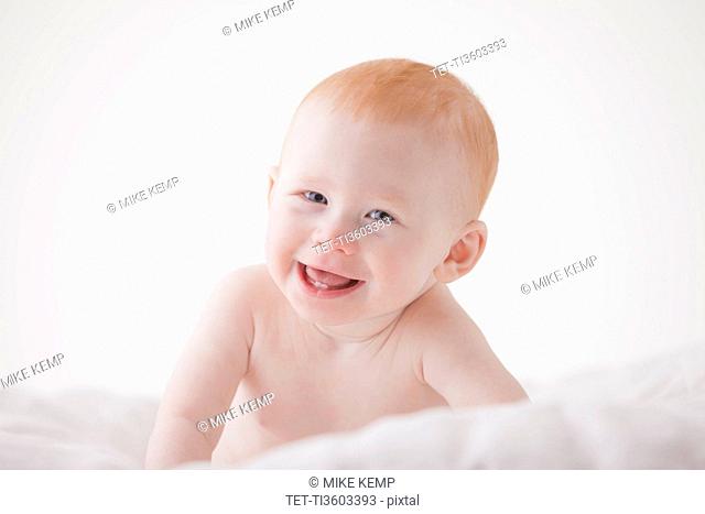 Portrait of baby boy (18-23 months) laughing