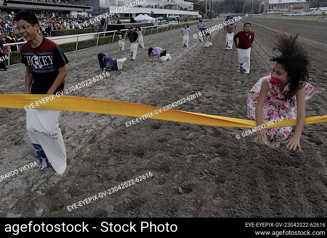 MEXICO CITY, MEXICO - APR 23, 2022: Children have fun during sack race as part to Botarga contest at the Hipódromo de las Américas