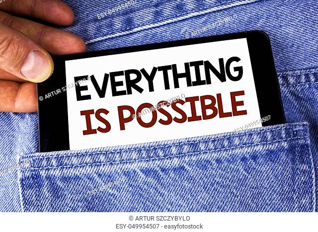 Conceptual hand writing showing Everything Is Possible. Business photo text All you think or dream can become true Optimistic written Mobile phone holding by...