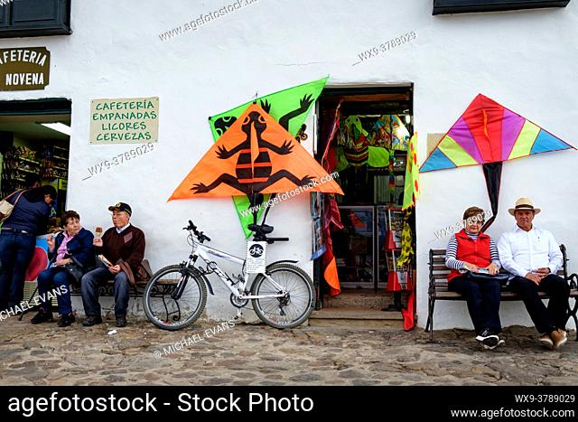 Tourists relax in front of a kite shop in Villa de Leyva, Colombia's Plaza Mayor. August is kite-flying season in Colombia