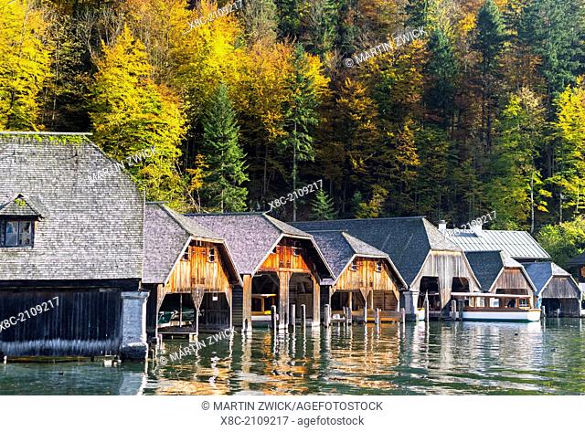 The jetty of schoenau village with traditional wodden boathouses for the excursion boats at lake Koenigssee, NP Berchtesgaden