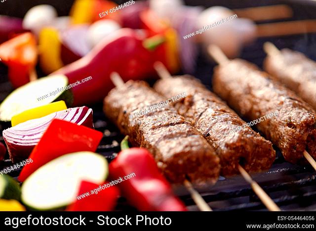 close up of barbecue kebab meat roasting on grill