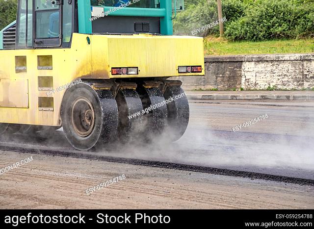 Close view on the working road roller. Street paving works