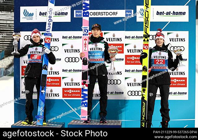 29 December 2021, Bavaria, Oberstdorf: Nordic skiing/ski jumping: World Cup, Four Hills Tournament. Ryoyu Kobayashi (M) from Japan cheers at the award ceremony...
