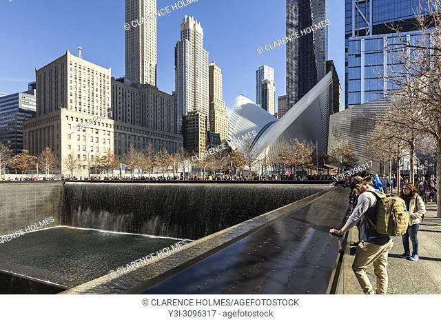 The North Pool of the National September 11 Memorial, with the Oculus World Trade Center Transportation Hub in the background in New York City