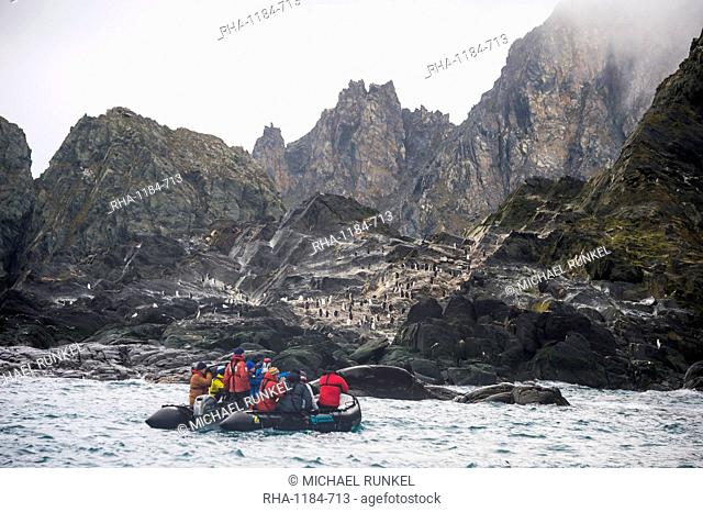 Tourists on a zodiac watching a dolphin colony, Elephant Island, South Shetland Islands, Antarctica, Polar Regions