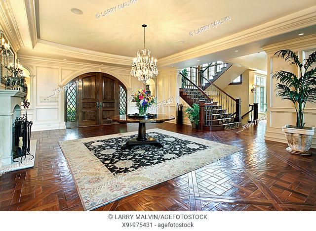Foyer in suburban mansion with fireplace