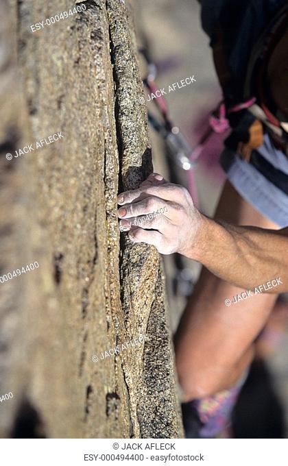 Rock Climber holding on to cliff close-up