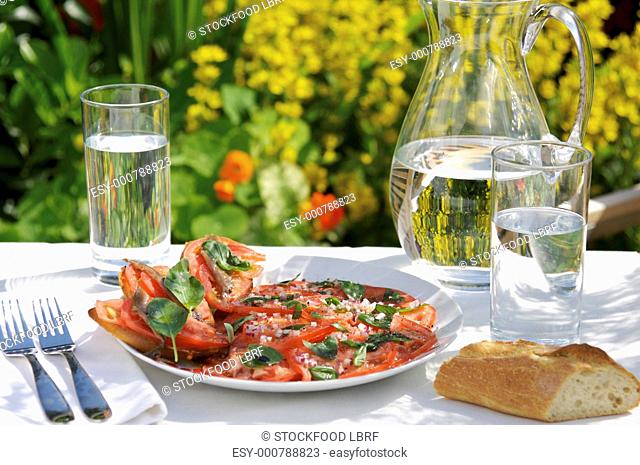 Tomato carpaccio with anchovy fillets and basil