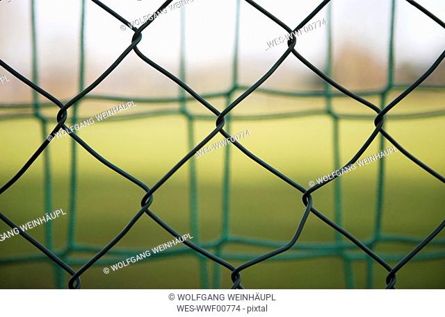 Wire fence, sports net in background