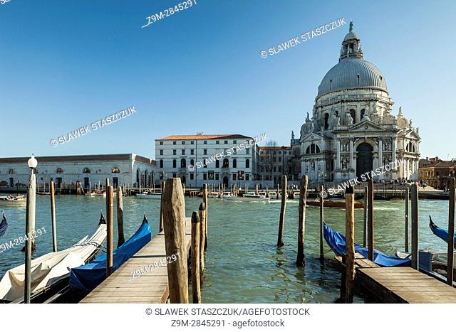 Afternoon on Grand canal in Venice, Italy. Iconic dome of the church of Santa Maria della Salute in the distance