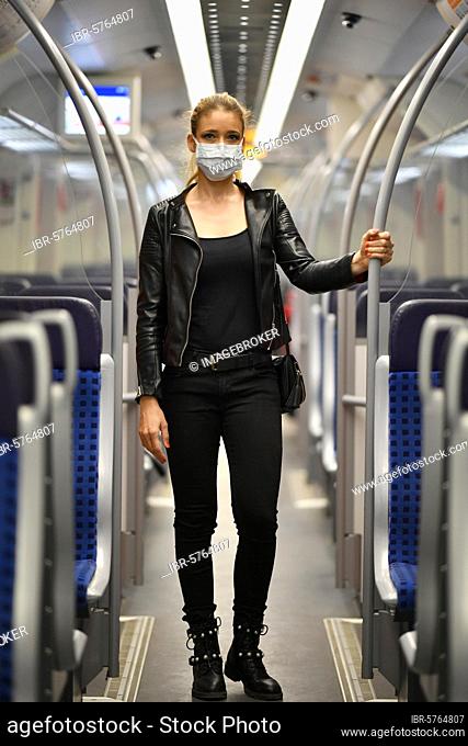 Woman with face mask, standing in suburban train, corona crisis, Stuttgart, Baden-Württemberg, Germany, Europe