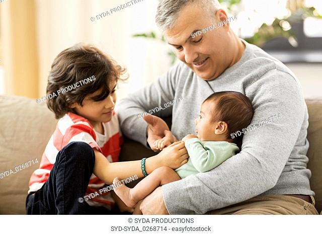 happy father with preteen and baby son at home