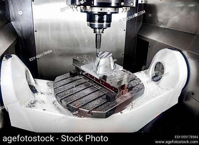 Metalworking CNC milling machine. Cutting metal modern processing technology. Small depth of field. Warning - authentic shooting in challenging conditions