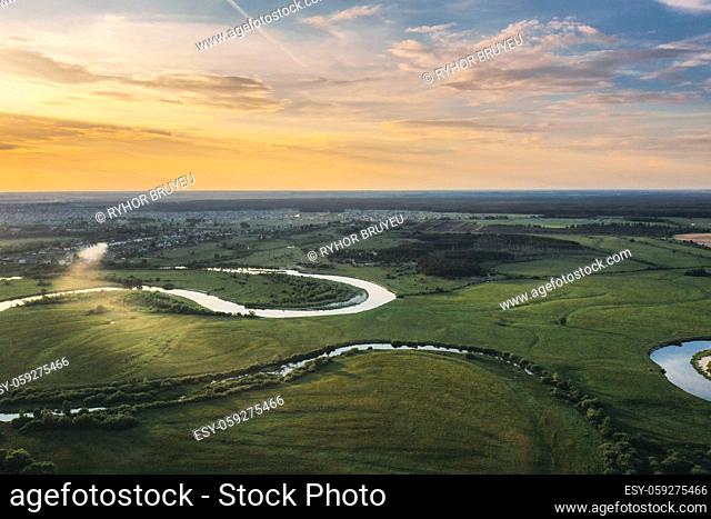 Aerial View. Sunset Sky Above Green Forest, Meadow And River Landscape In Sunny Evening. Top View Of European Nature From High Attitude In Summer Sunrise