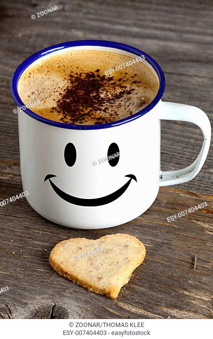 Coffee cup with smiley face and a cookie