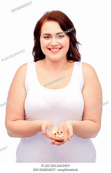 weight loss, diet, slimming, medicine and people concept - happy plus size woman in underwear with pills