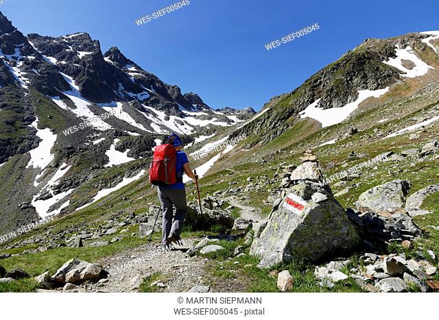 Austria, Vorarlberg, Woman hiking at Grafierjoch and Schafberg