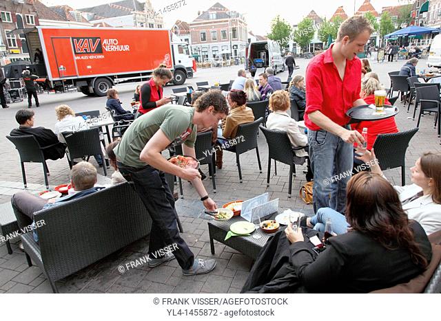 People ordering and enjoing food and drinks on a terrace on The Hof, Amersfoort, Netherlands