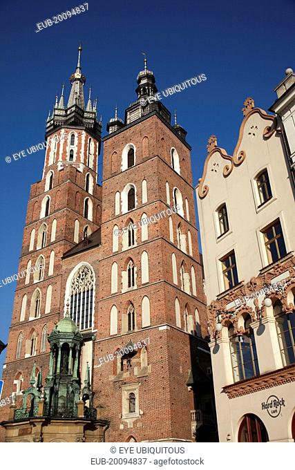 Stare Miasto. Mariacki Basilica or Church of St Mary s. Angled view of red brick Gothic exterior completed in 1397 built on older foundations the two towers of...