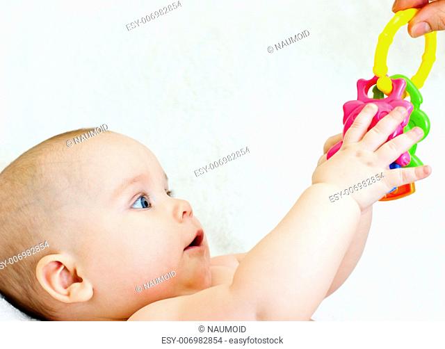 Little baby girl taking teething toy