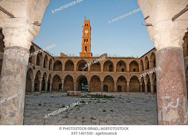 Israel, Acre, The clock tower and walls of the old hostel Khan el Omdan as seen from within the courtyard