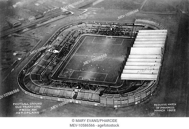 Old Trafford football ground, aerial view. Manchester.   The image was taken from an aeroplane, a reserve match is in progress