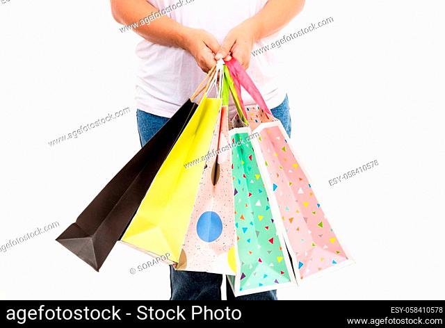 Happy woman hand holding shopping bags multicolor, young female hold many packets within arms isolated on white background, Black friday sale concept