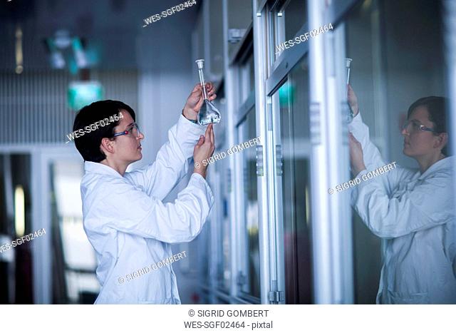 Female chemist at work examining a liquid