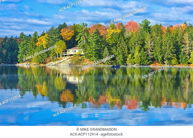 Horseshoe Lake in autumn with cottage , Near Parry Sound, Ontario, Canada