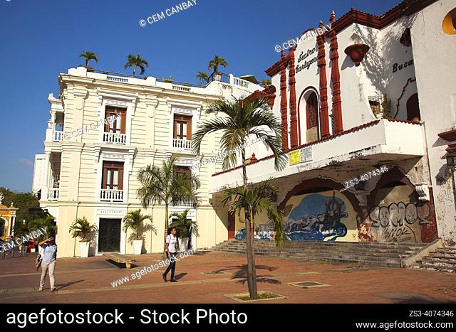 Local people walking in front of the colonial buildings used as Teatro Cartagena at the historic center, Cartagena de Indias, Bolivar, Colombia, South America