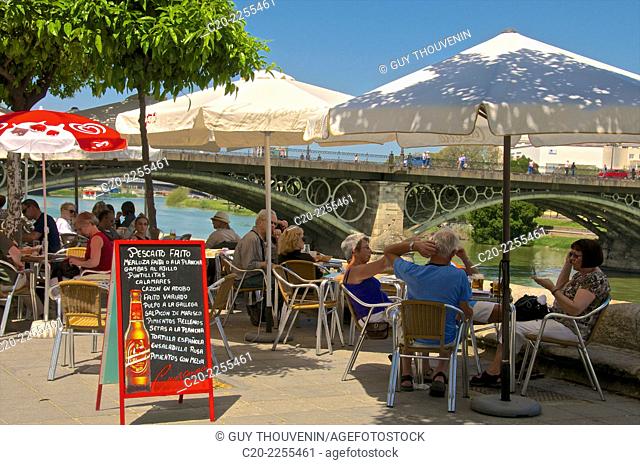 Cafe terrace along the Guadalquivir river, Triana, Aperitif time, customers, Sevilla, Andalusia, Spain