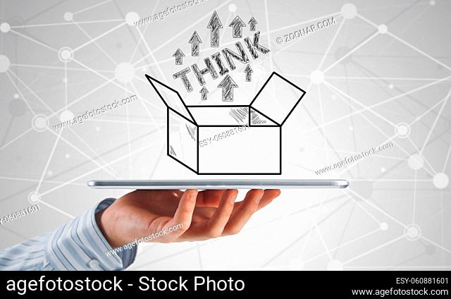 Hand of businessman holding tablet pc with creativity concept