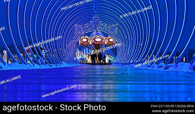 30 November 2023, Thuringia, Hohenfelden: Thousands of lights shine on the opening day of the Thuringian Glitter World in the Hohenfelden reservoir play and sun...