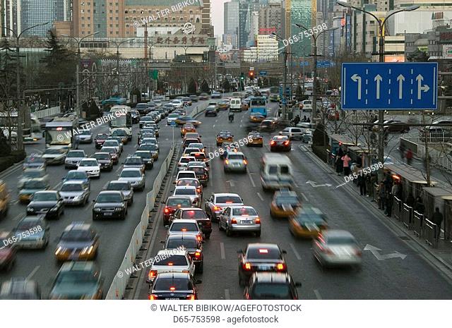 China. Beijing. Chaoyang District. Chaoyangmenwai Dajie, main road in north-eastern commercial district, evening traffic