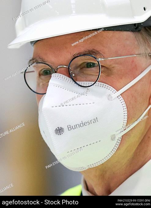 29 March 2021, Saxony-Anhalt, Halle: Reiner Haseloff (CDU), Minister President of Saxony-Anhalt, stands in the new joint press shop of Porsche and Schuler...
