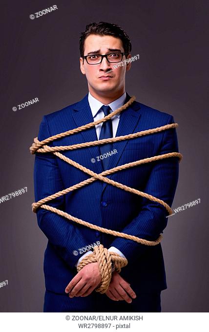 Businessman tied up with rope