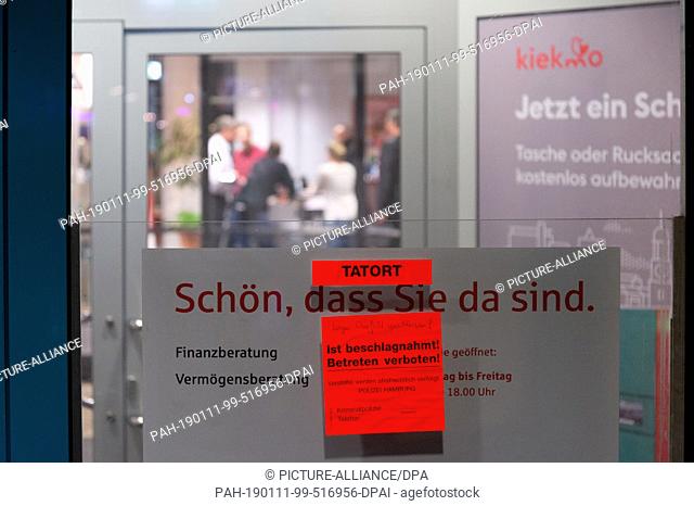 10 January 2019, Hamburg: A police sticker on a window of a bank indicates a ""crime scene"" and that the branch is closed with the remark: ""Closed due to...