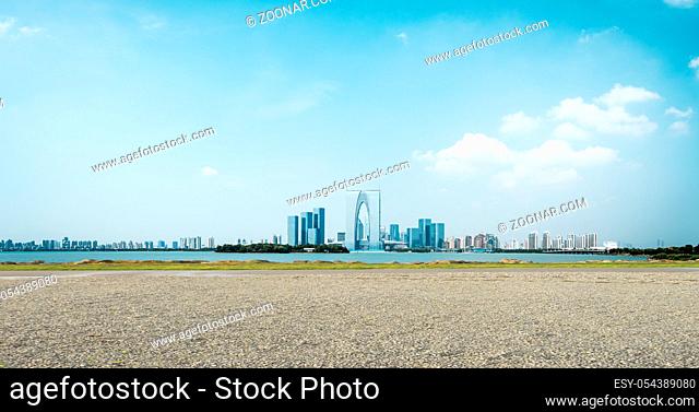 empty ground and cityscape of modern city near water