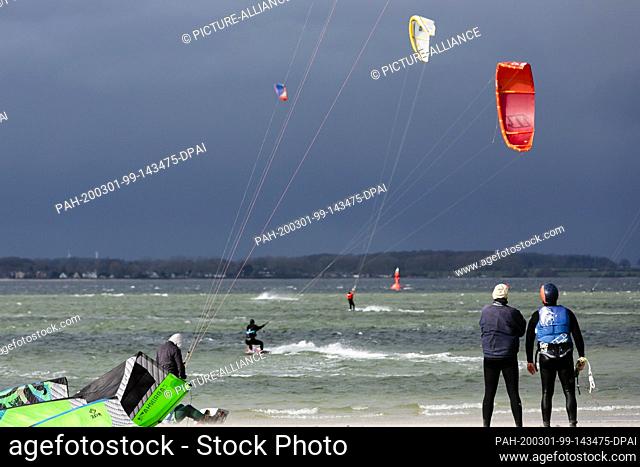 01 March 2020, Schleswig-Holstein, Laboe: Kitesurfers glide over the Baltic Sea in changeable weather. Photo: Frank Molter/dpa