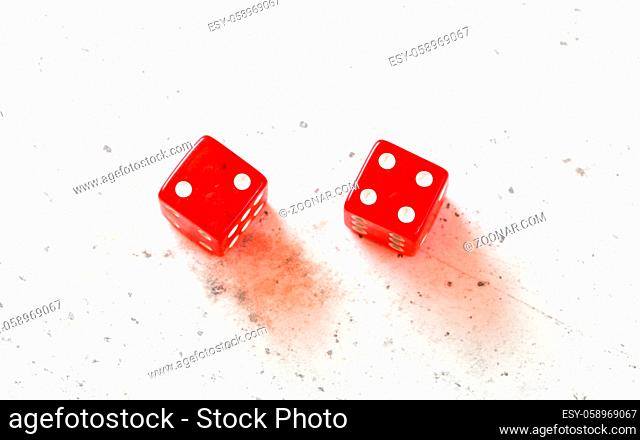 Two red craps dices showing Easy Six Jimmie Hicks number 2 and 4 overhead shot on white board