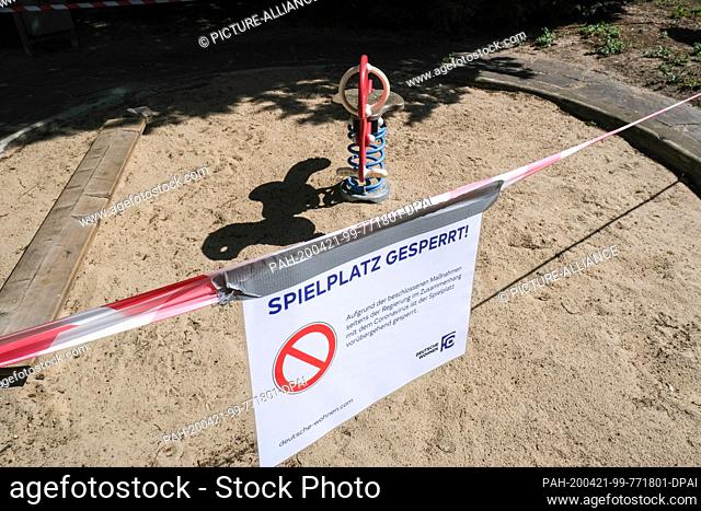 17 April 2020, Berlin: Barrier tapes and a sign ""Spielplatz gesperrt"" (playground closed) are attached to a playground in Charlottenburg