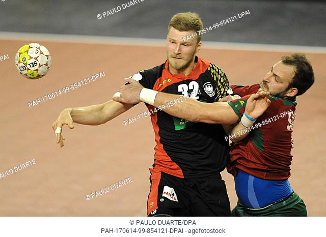 GermanyÂ·s Philipp Weber, left, challenges PortugalÂ·s Daymaro Salina for the ball during the Euro 2018 Qualification Group 5 handball match between Portugal...