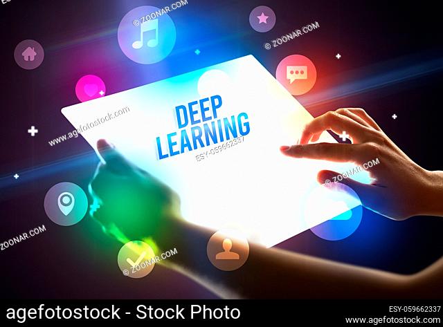 Holding futuristic tablet with DEEP LEARNING inscription, new technology concept
